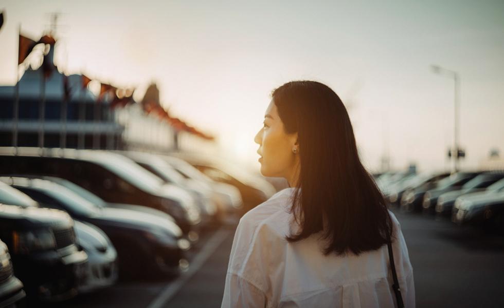 Woman at car lot